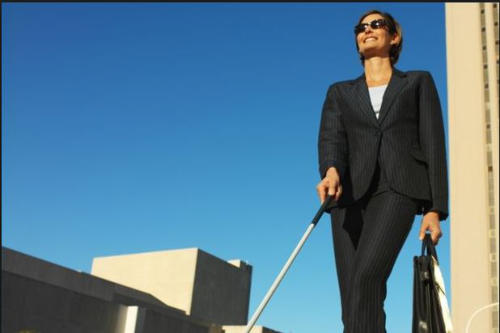 Blind Business Woman walking with cane.